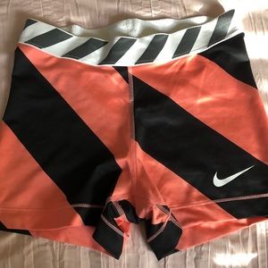 Coral and black stripped Nike Pros